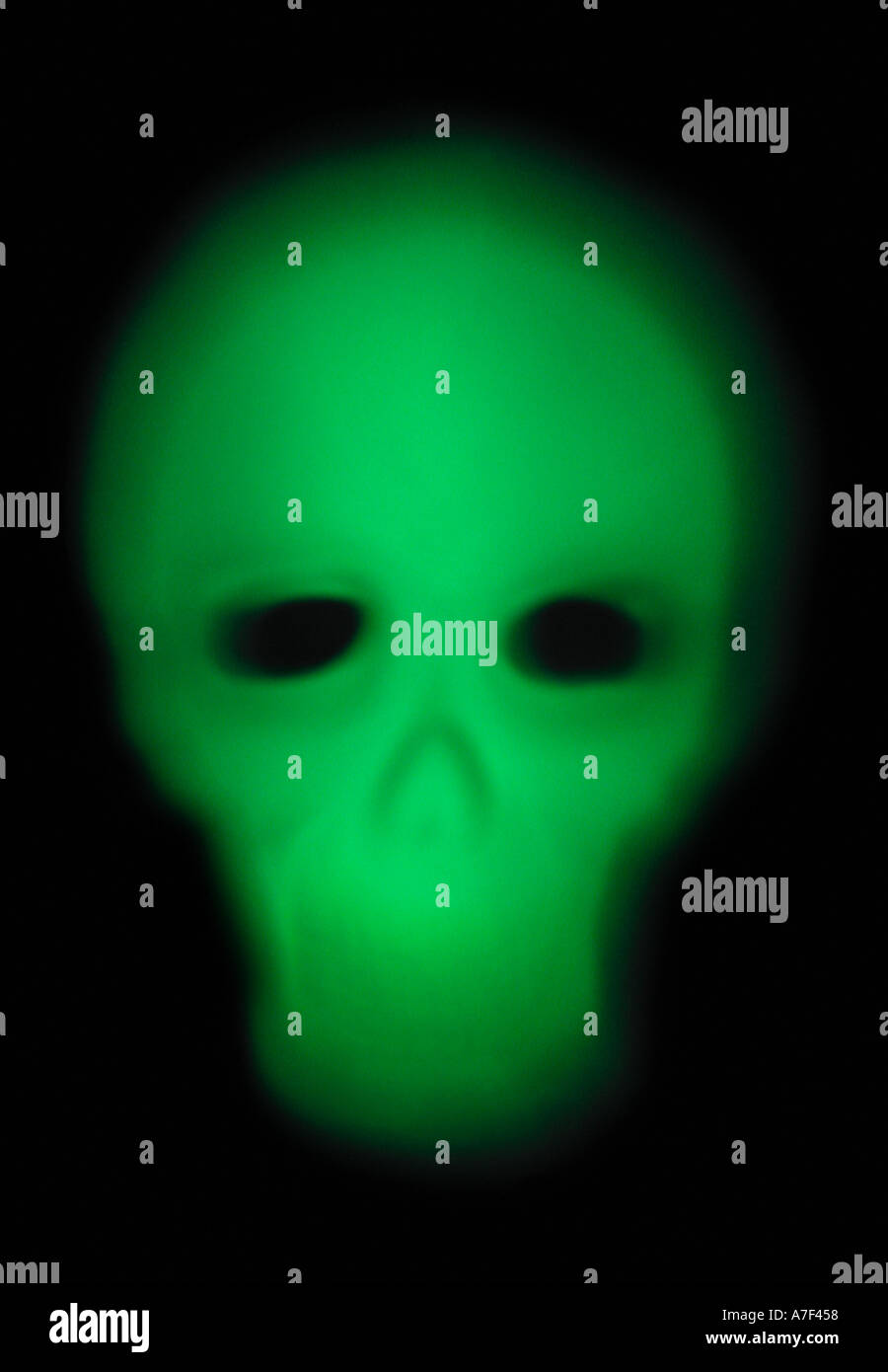 A scary ghost like green blurry glowing skull or skeleton face Stock Photo