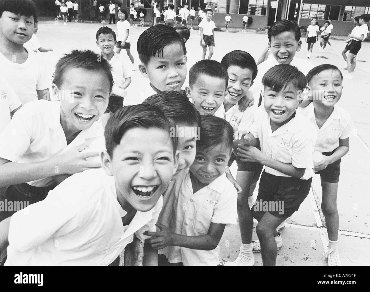 happy children singapore school laughing playing Stock Photo