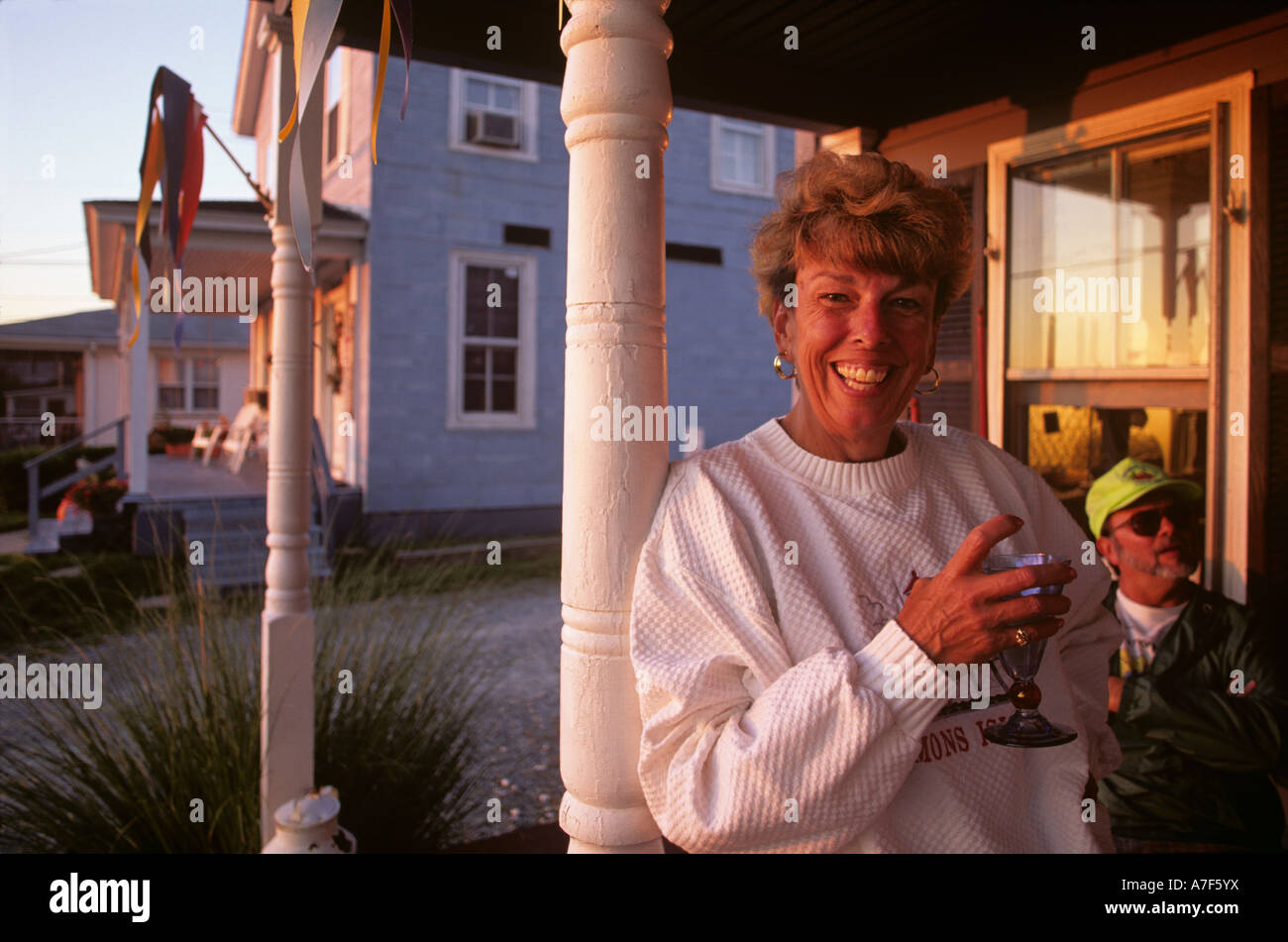 Pituck USA Maryland Solomons Island MR Carin Pituck sips wine while watching ...