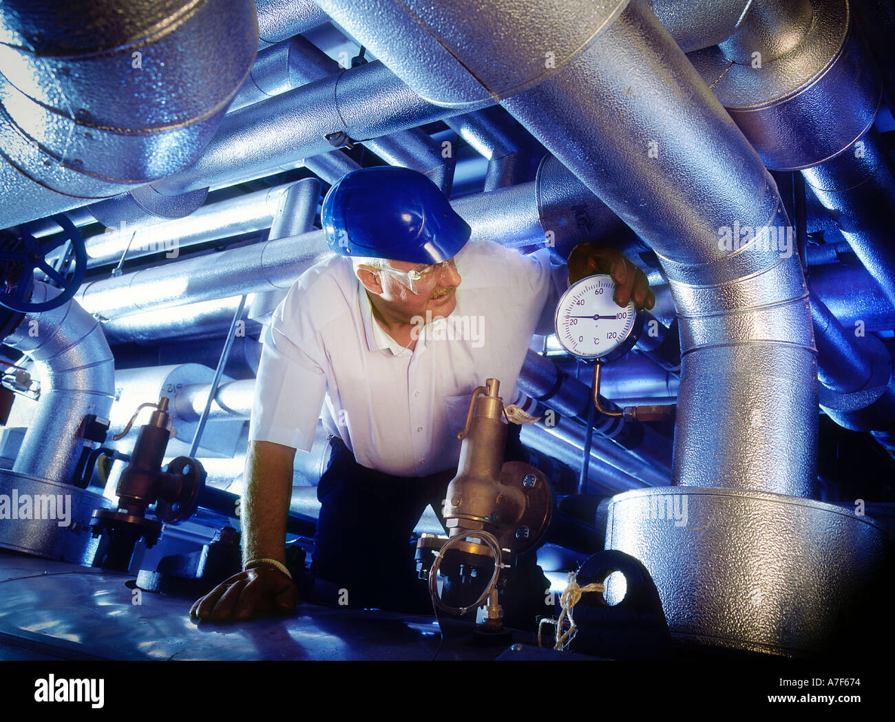 Engineer inspecting ventialtion ducts office building London UK Stock