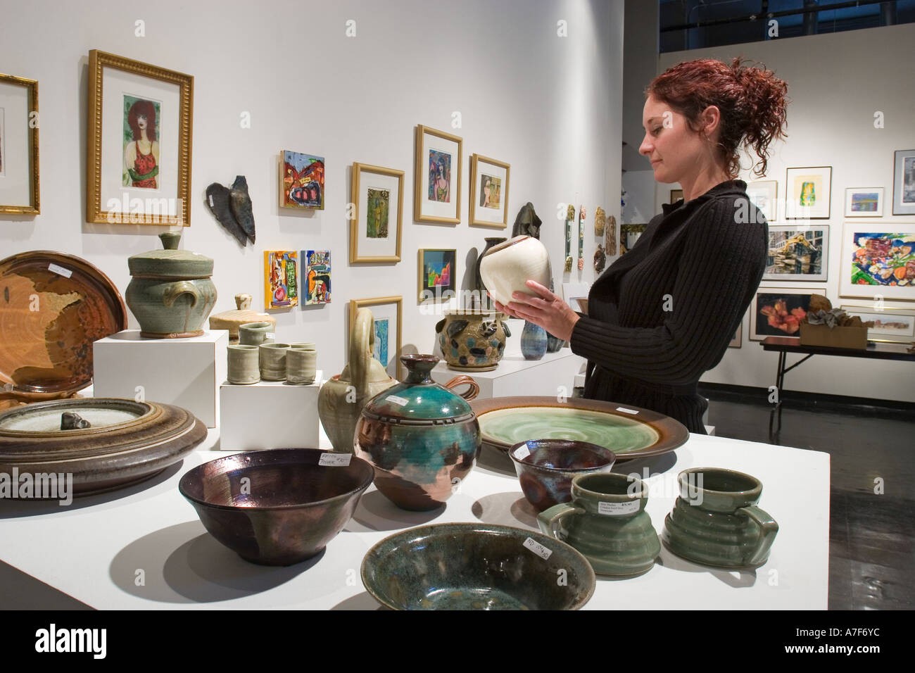 Detroit Michigan Shopper looks at a vase on sale at the Detroit Artists Market Stock Photo