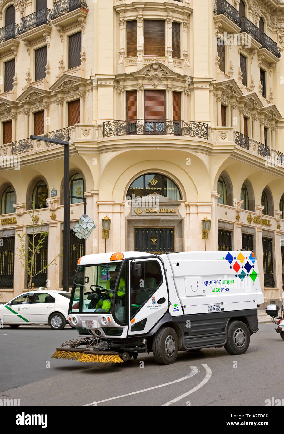 Municipal street cleaning machine truck with old buildings behind Granada Spain Stock Photo