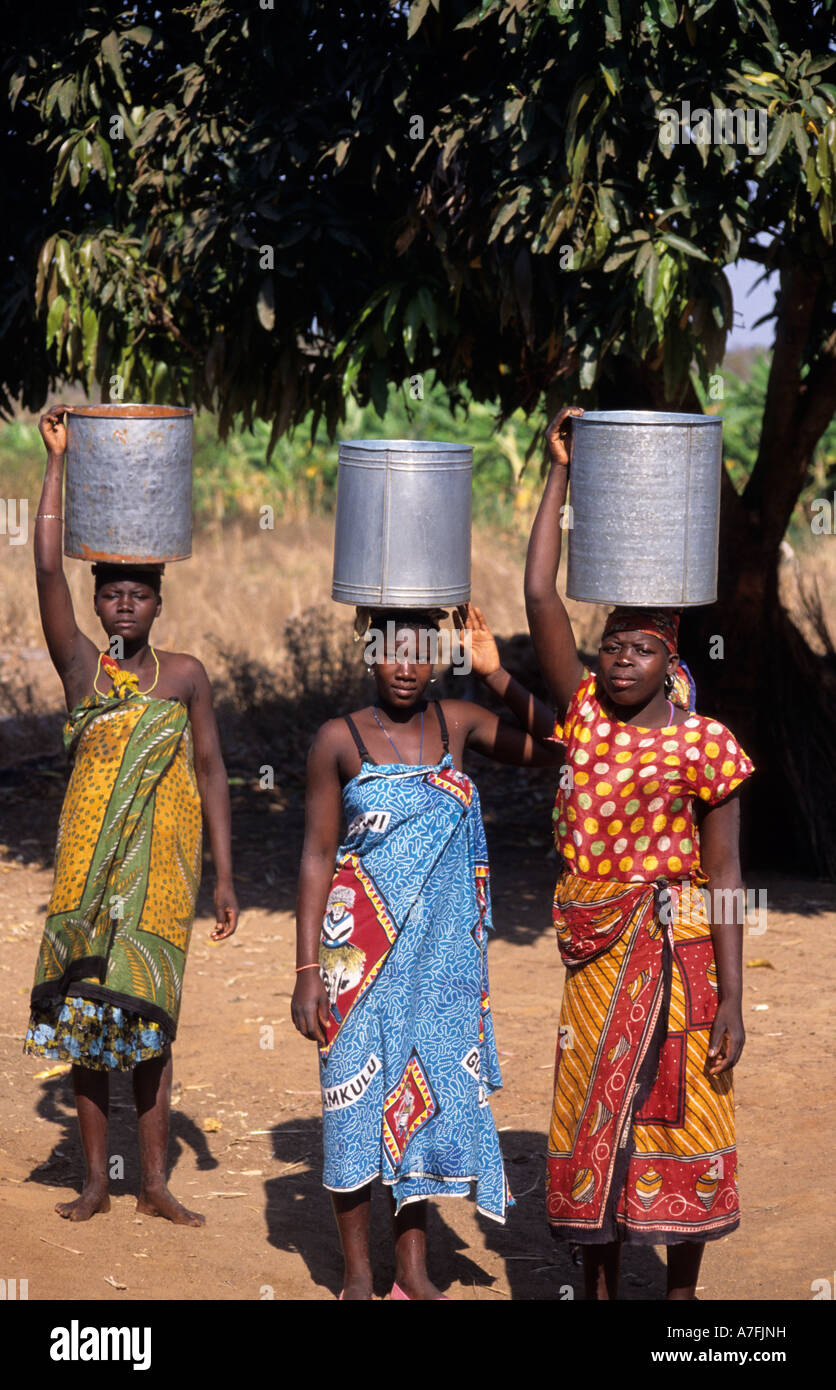 Africa.Mozambique. Collecting water .Three women with buckets on their heads Stock Photo Alamy
