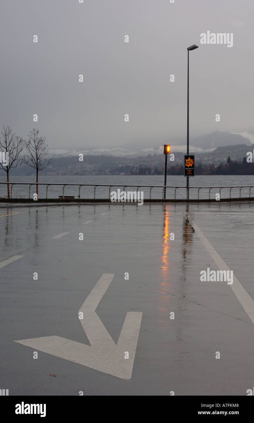Road marking on ferry loading area during storm Meilen Zürich Switzerland Stock Photo