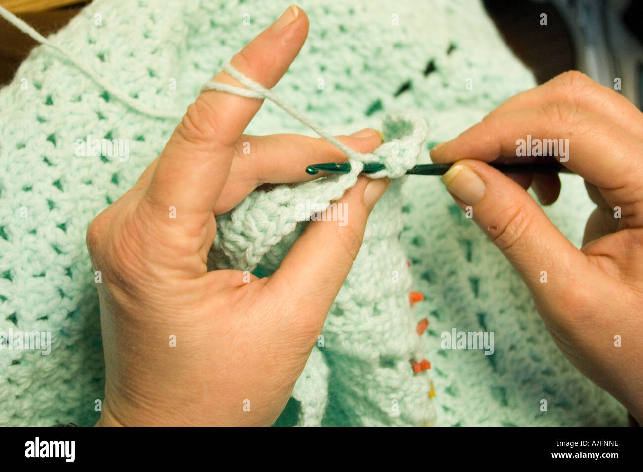 Womans hands crocheting baby blanket Stock Photo