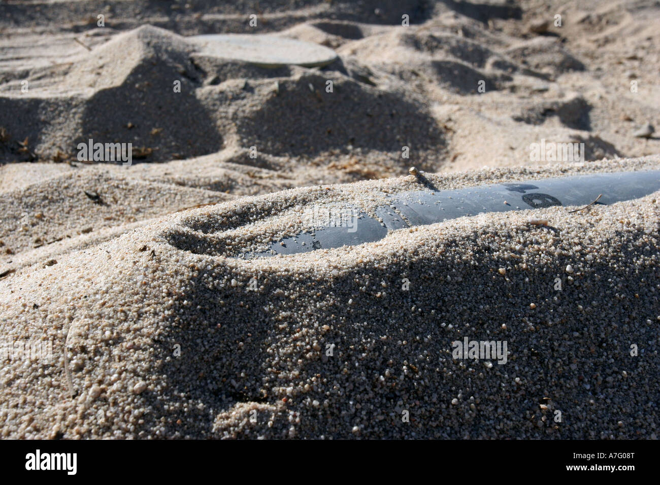 A static display of an ordnance shell and a mine lay half-buried in the ...