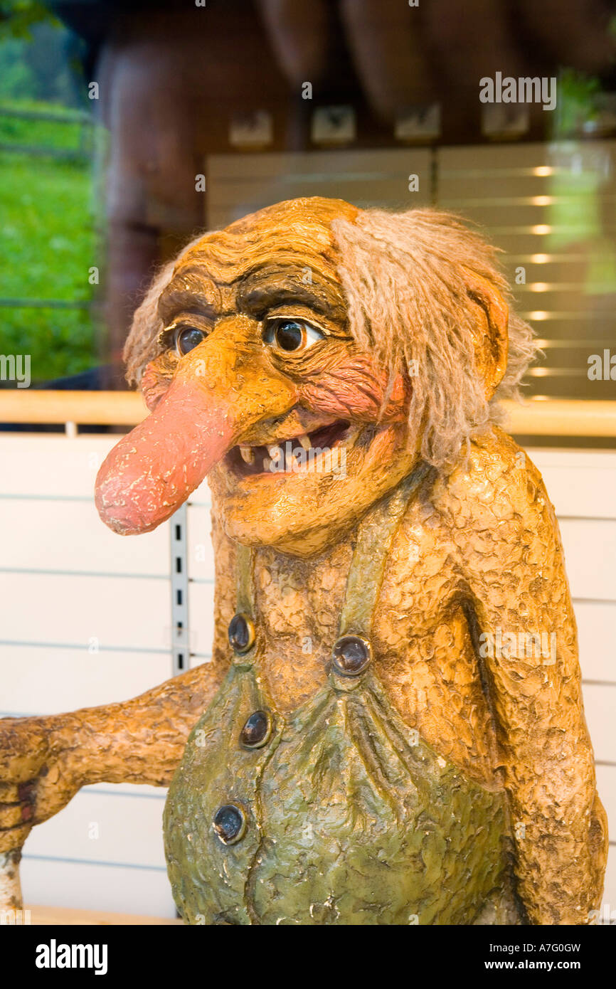 One meter tall statue of Swiss troll decorates store window in Interlaken Switzerland Stock Photo
