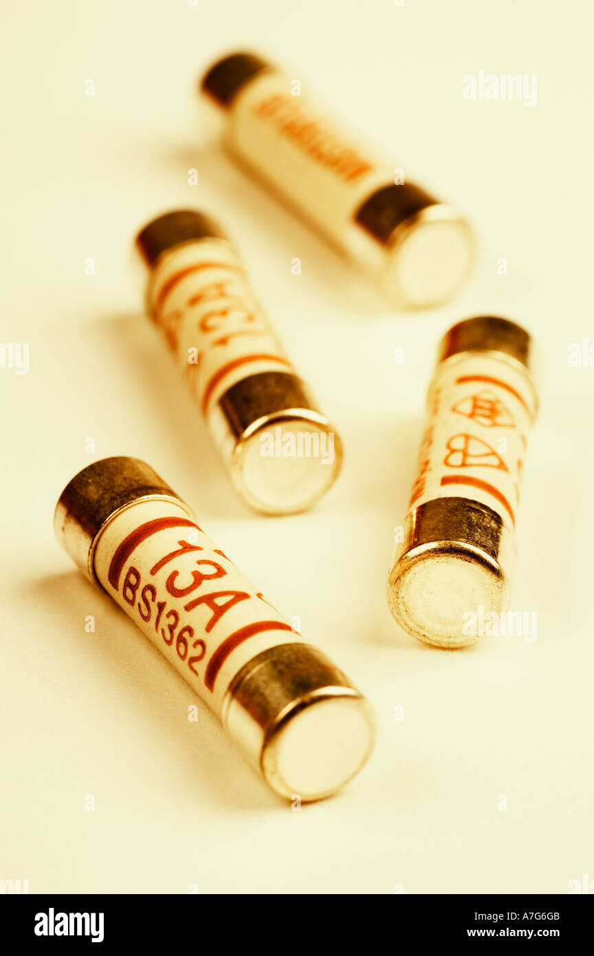 Four  13amp  fuses on a plain background. Tinted copper. Stock Photo
