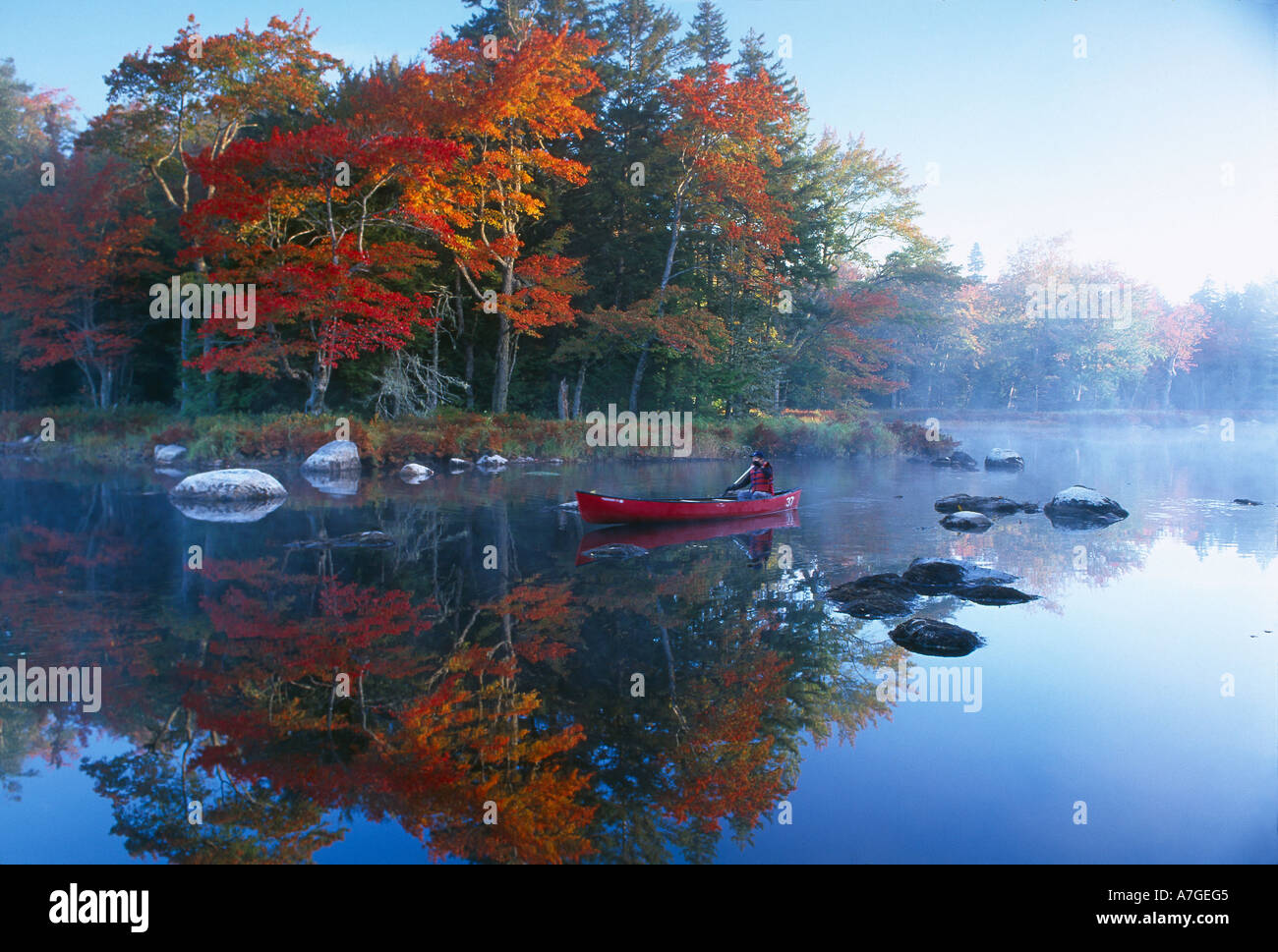Autumn Mersey River with canoe nr Kejimkujik National Park Nova Scotia