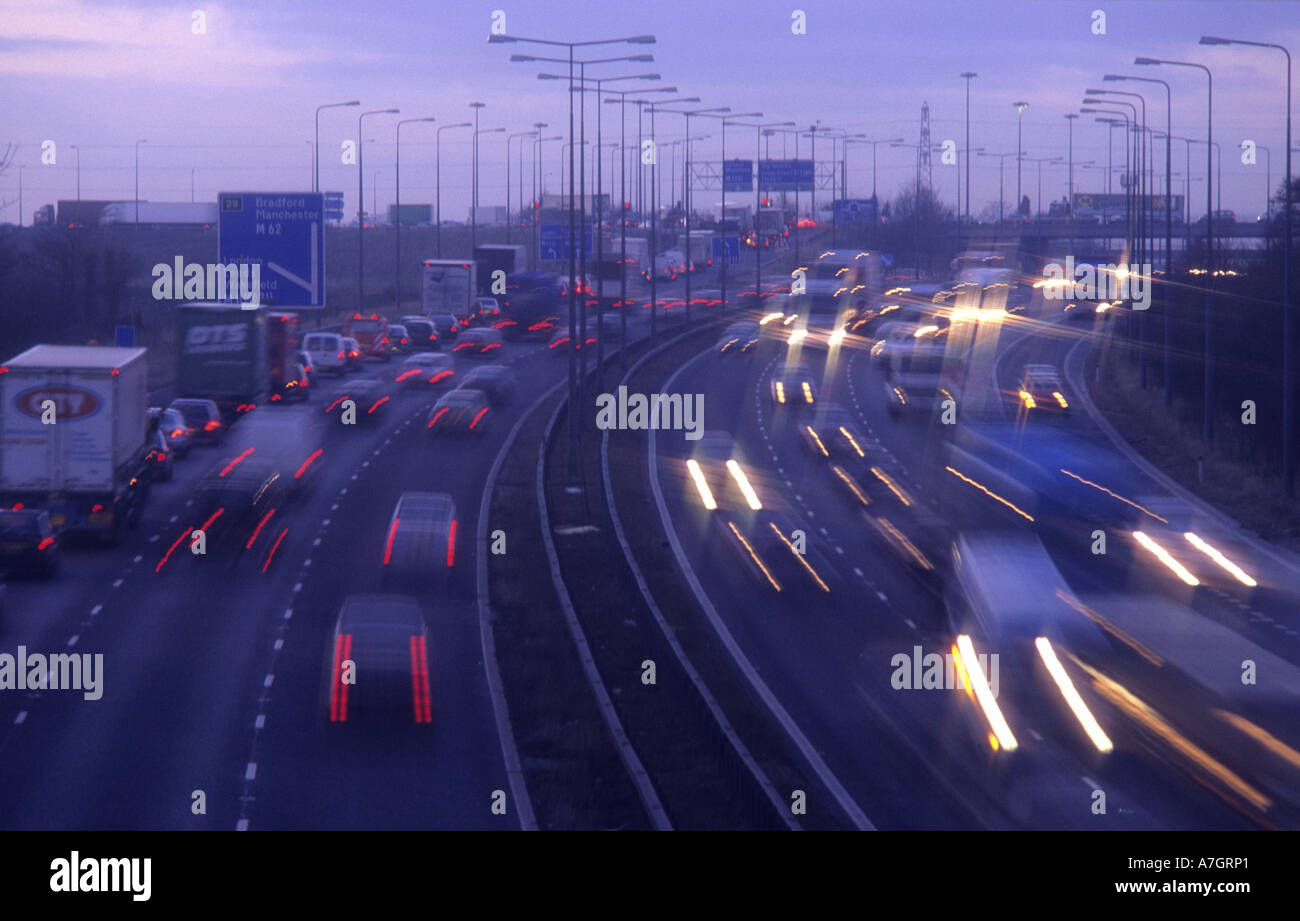 headlight trails of  traffic travelling on the M62  motorway at dusk leeds uk Stock Photo
