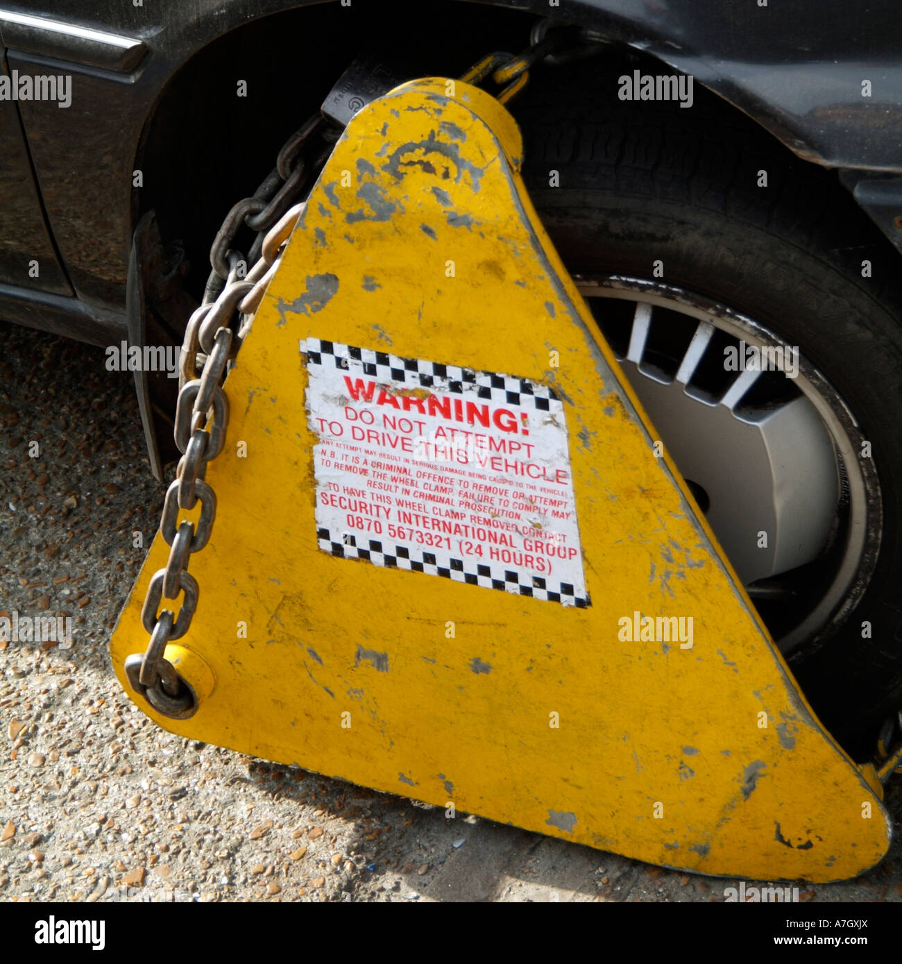 Wheel clamp on a parked car attached to one of the front wheels Parking