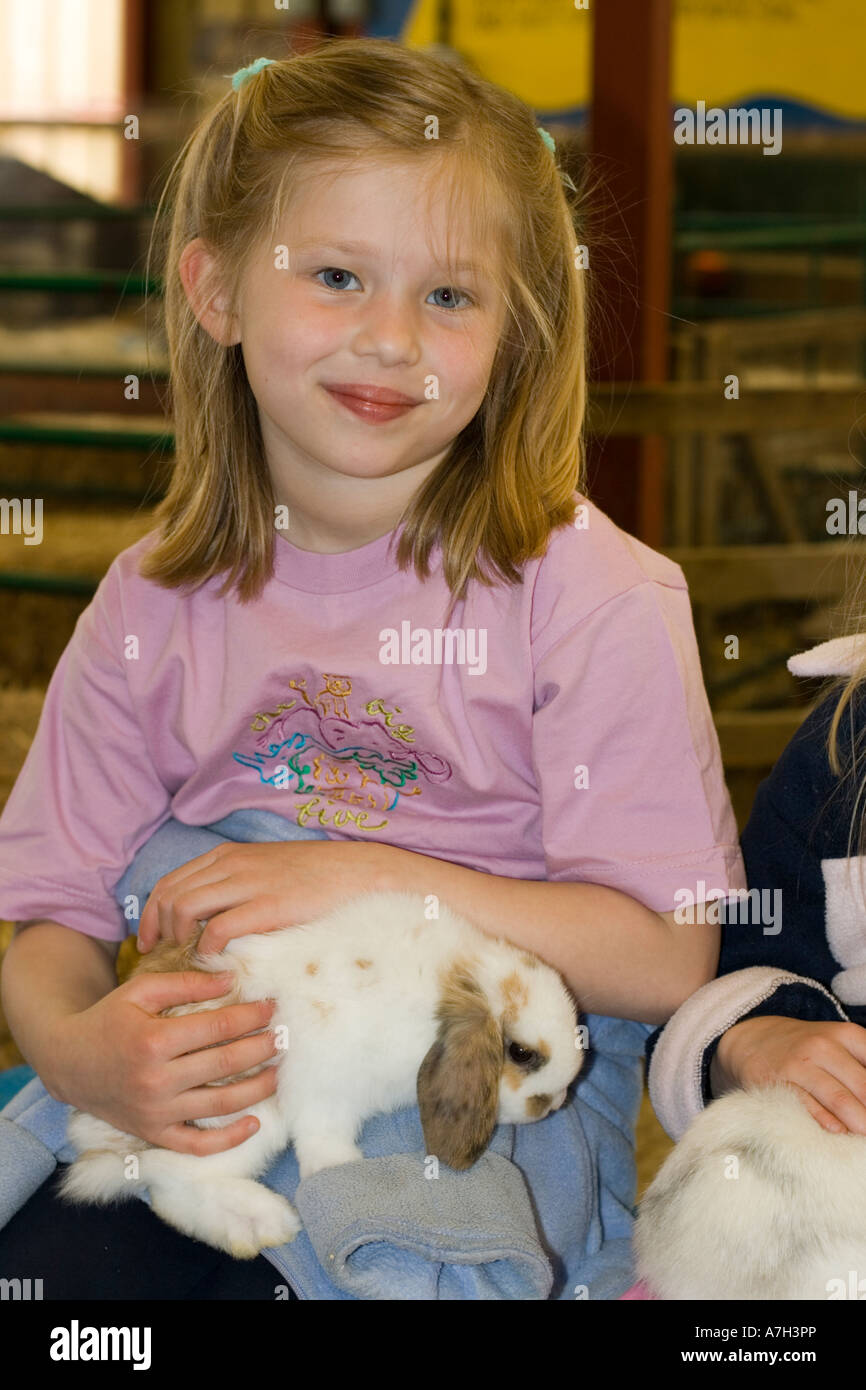 Young girl holding lop eared rabbit Rare Breed Trust Cotswold Farm Park