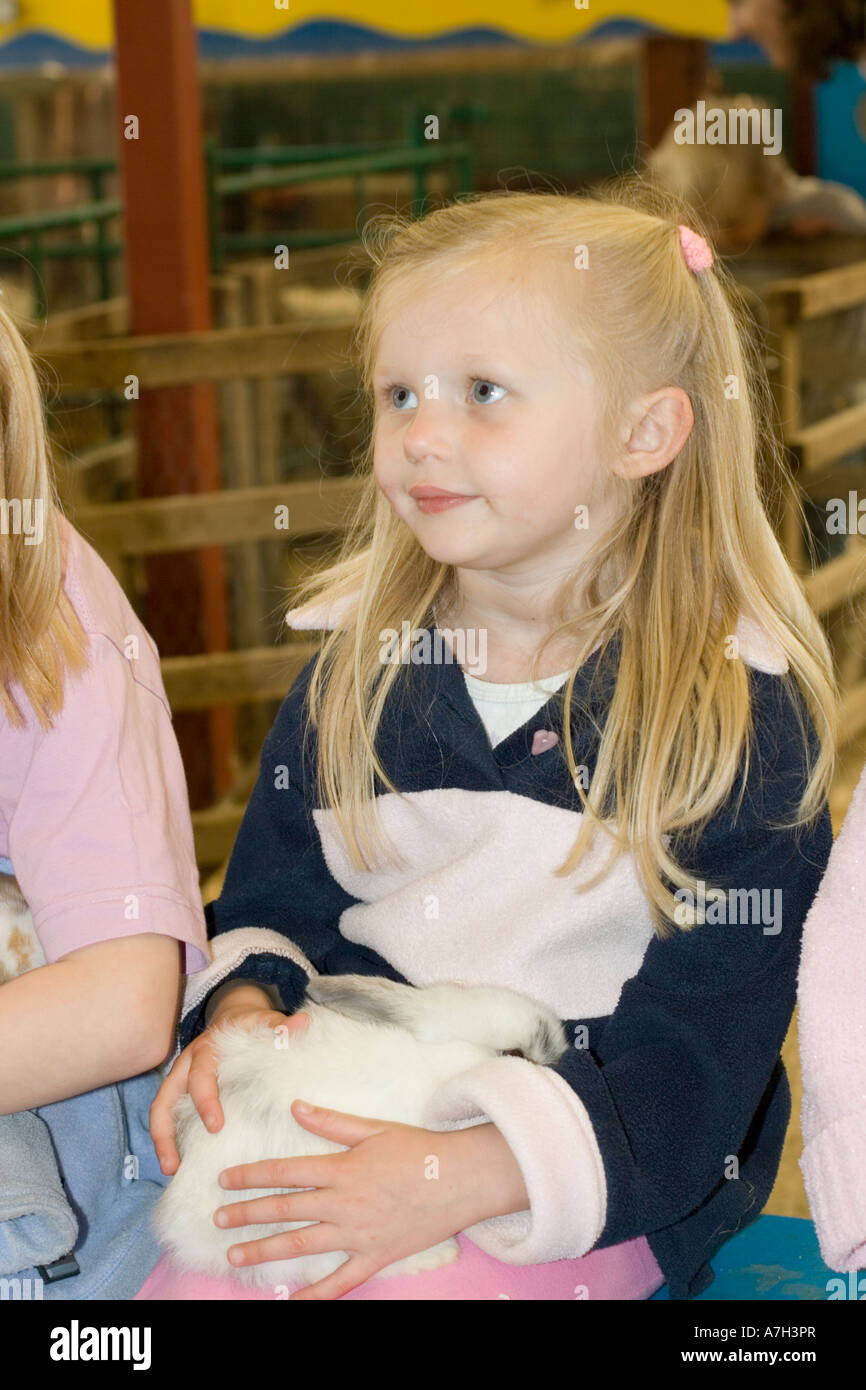 Young girl holding lop eared rabbit Rare Breed Trust Cotswold Farm Park