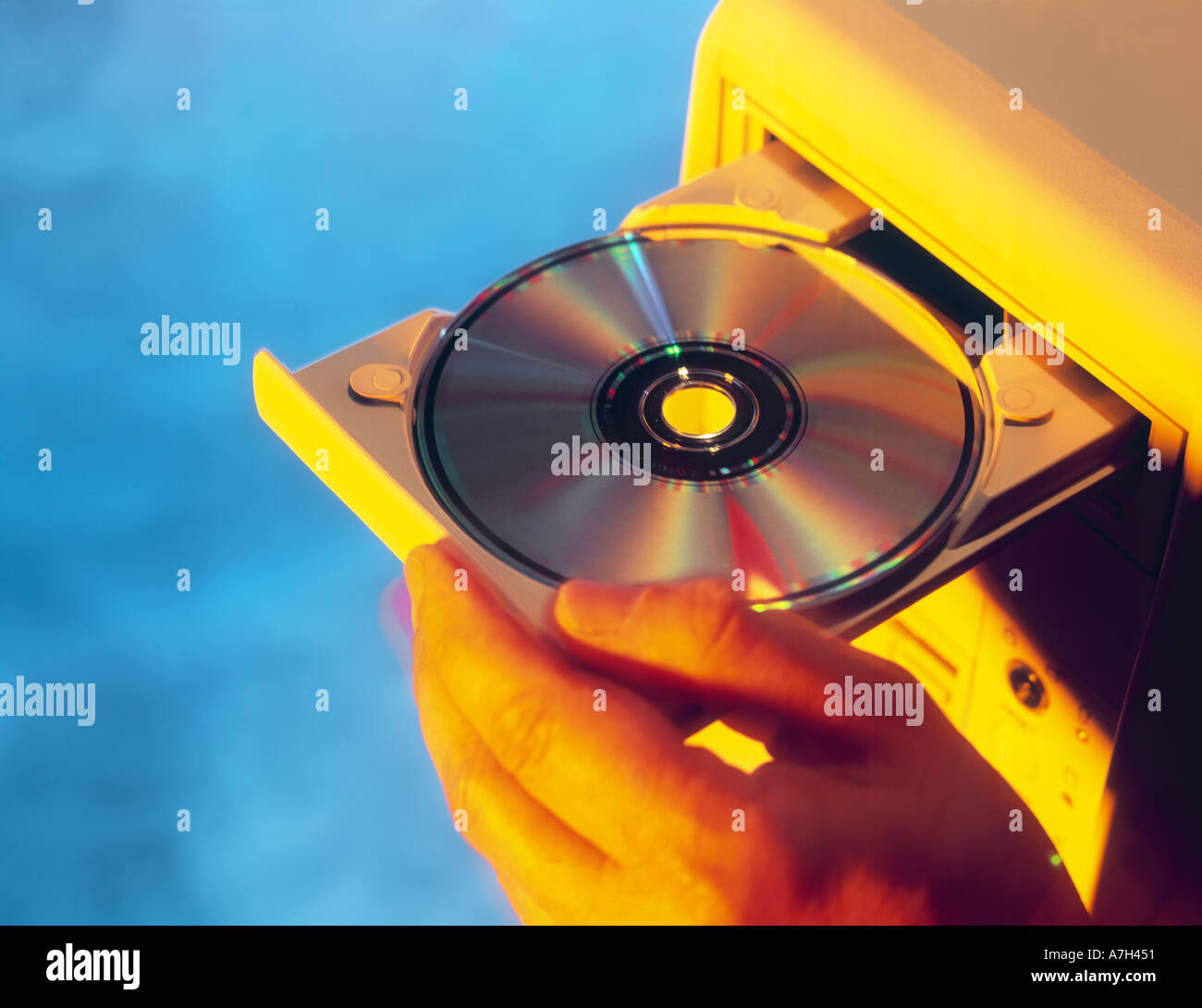 HAND LOADING CD INTO COMPUTER Stock Photo Alamy