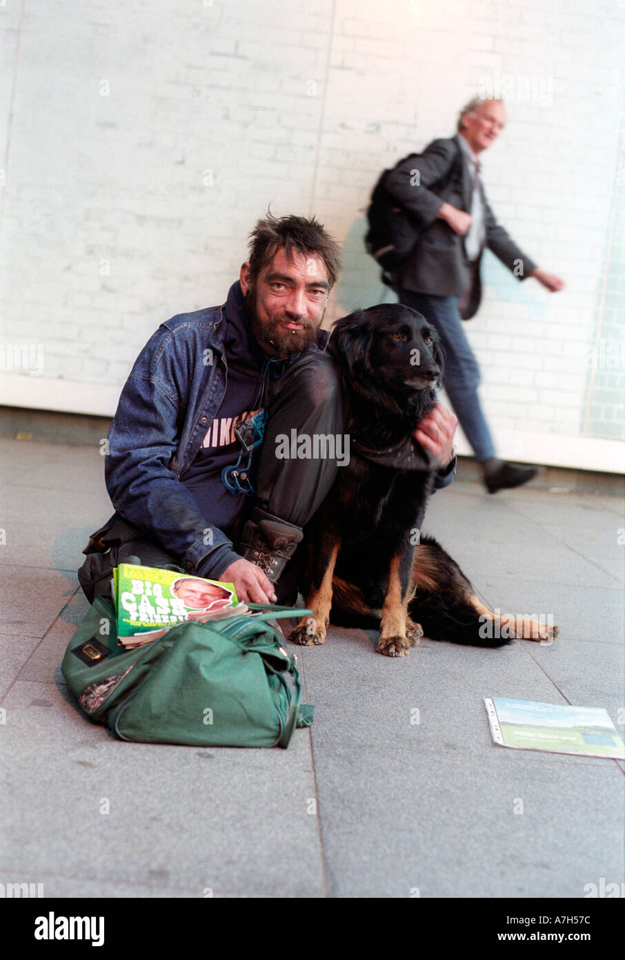 Homeless big issue seller with his dog on streets of London. Stock Photo