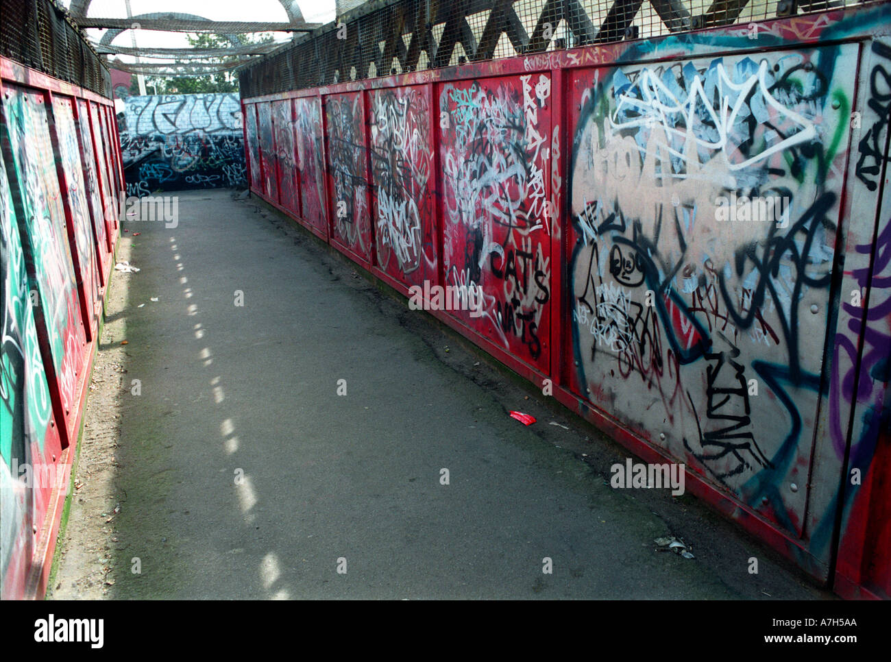 Innercity grafitti on railway bridge crossing. Stock Photo