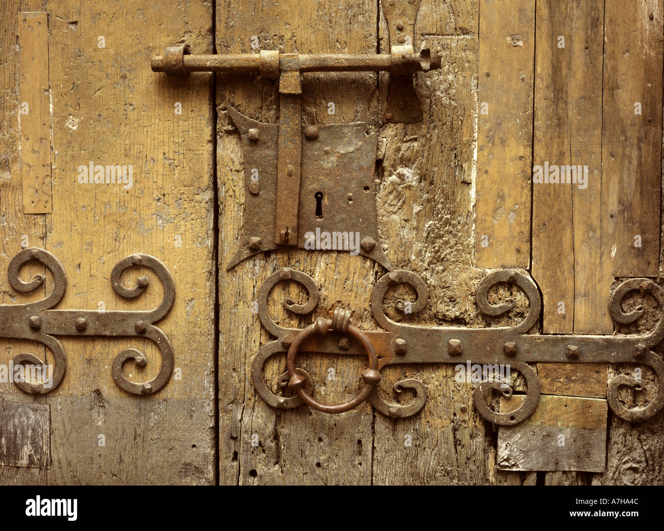 Iron lock on wooden door of the 13th Century church of St Jacques at Villefranche de Conflent in the Pyrenees Orientales, France Stock Photo