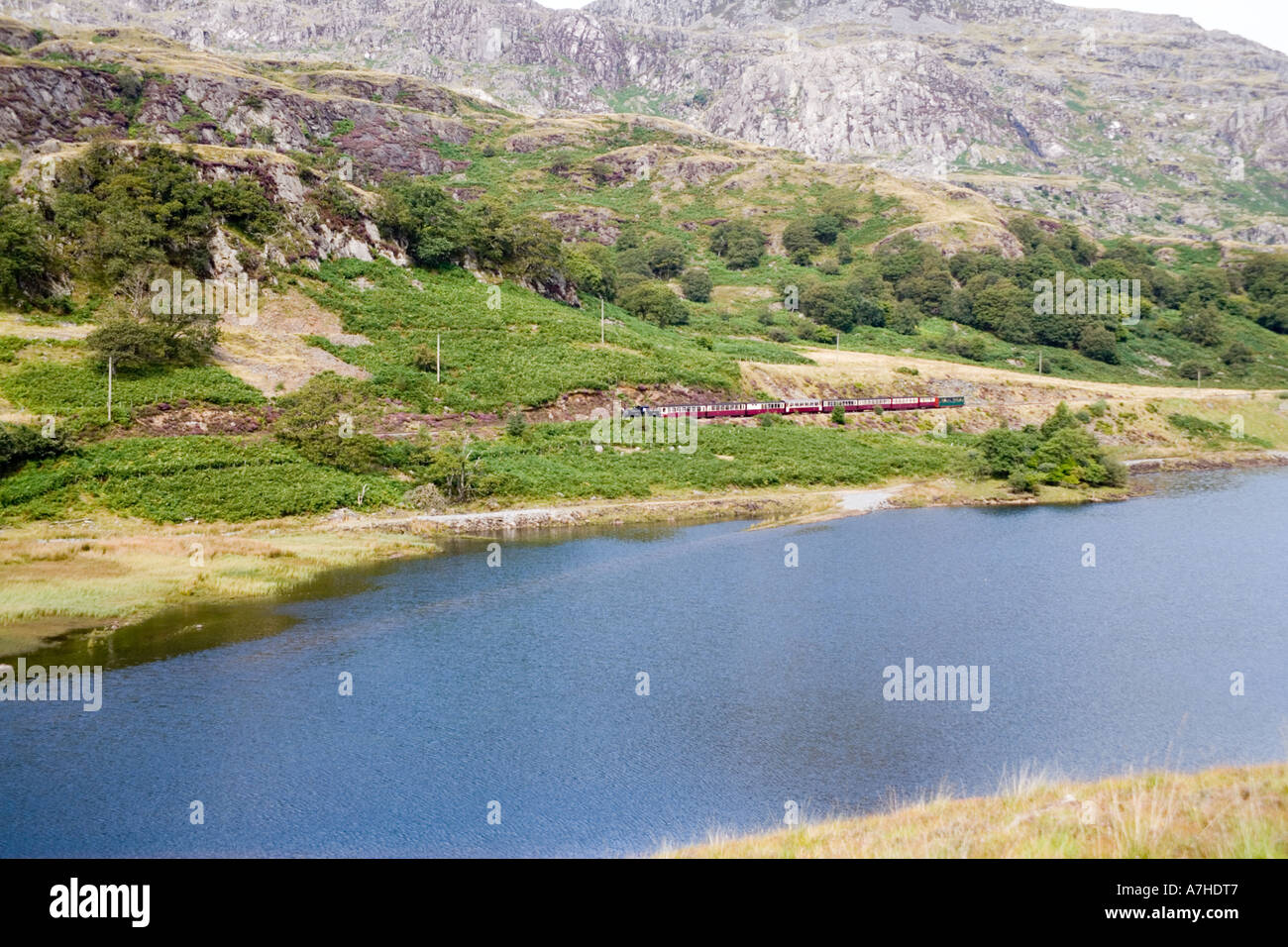 Steam train on the Ffestiniog railway passing Tanygrisiau reservoir
