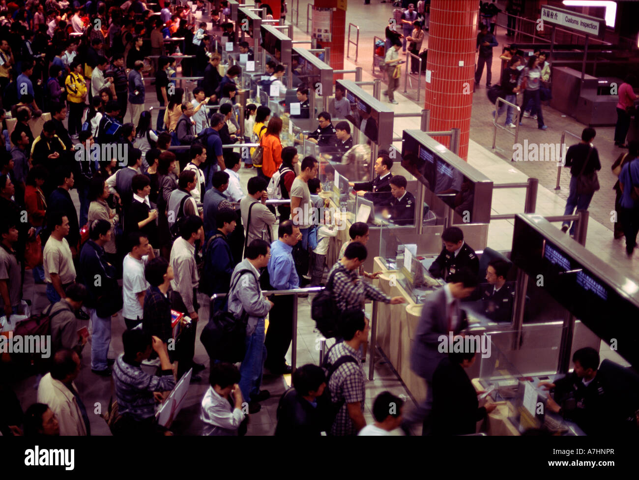 Crowds of people queue at the customs and immigration channels Stock Photo