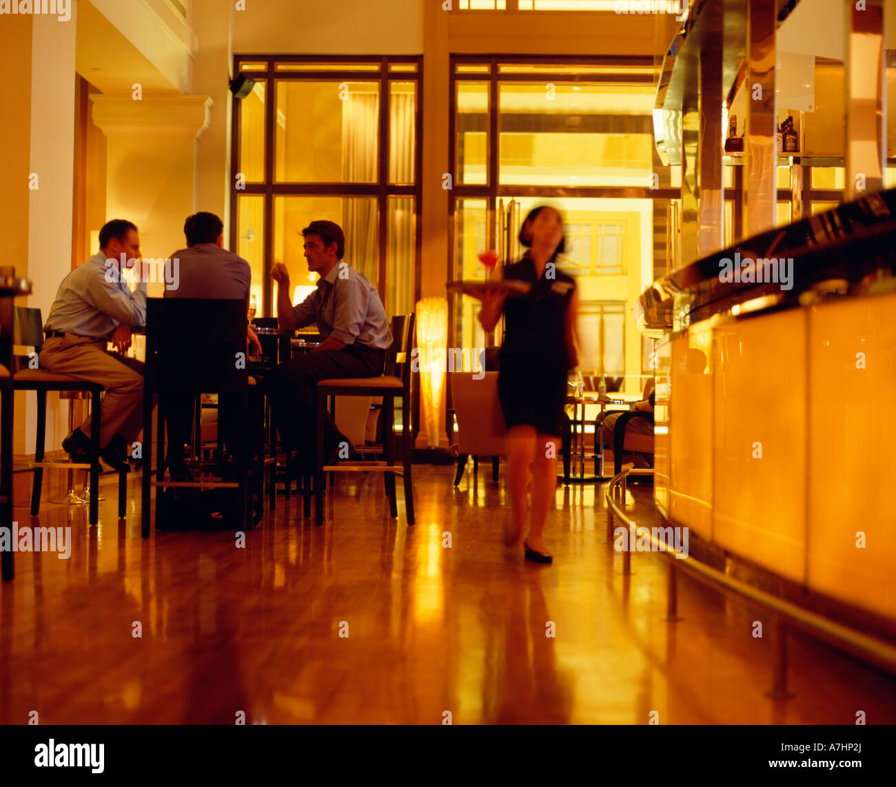 A female waitress serving cocktails inside the Post Bar and the