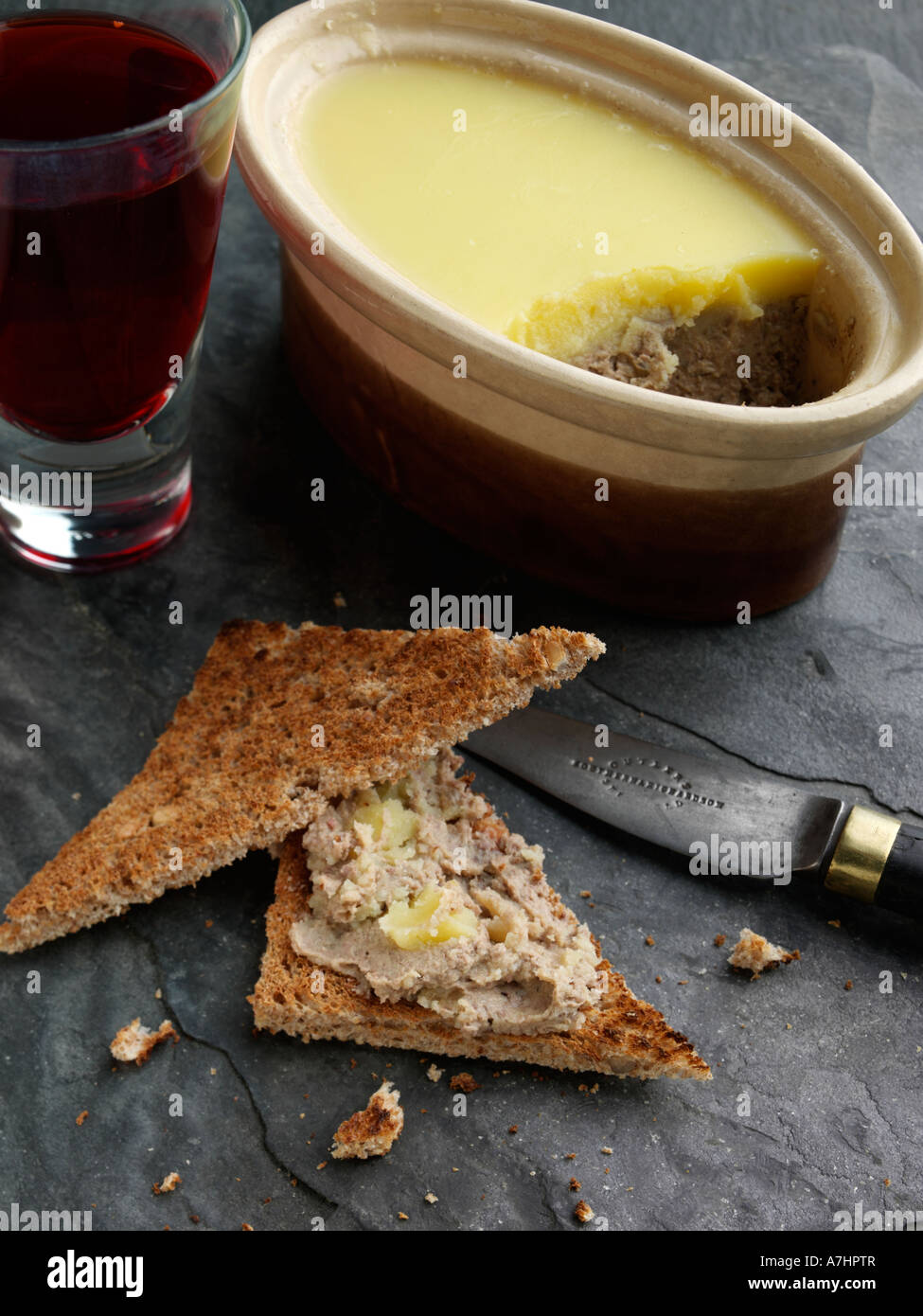 A dish of chicken liver pate with toast and wine editorial food Stock