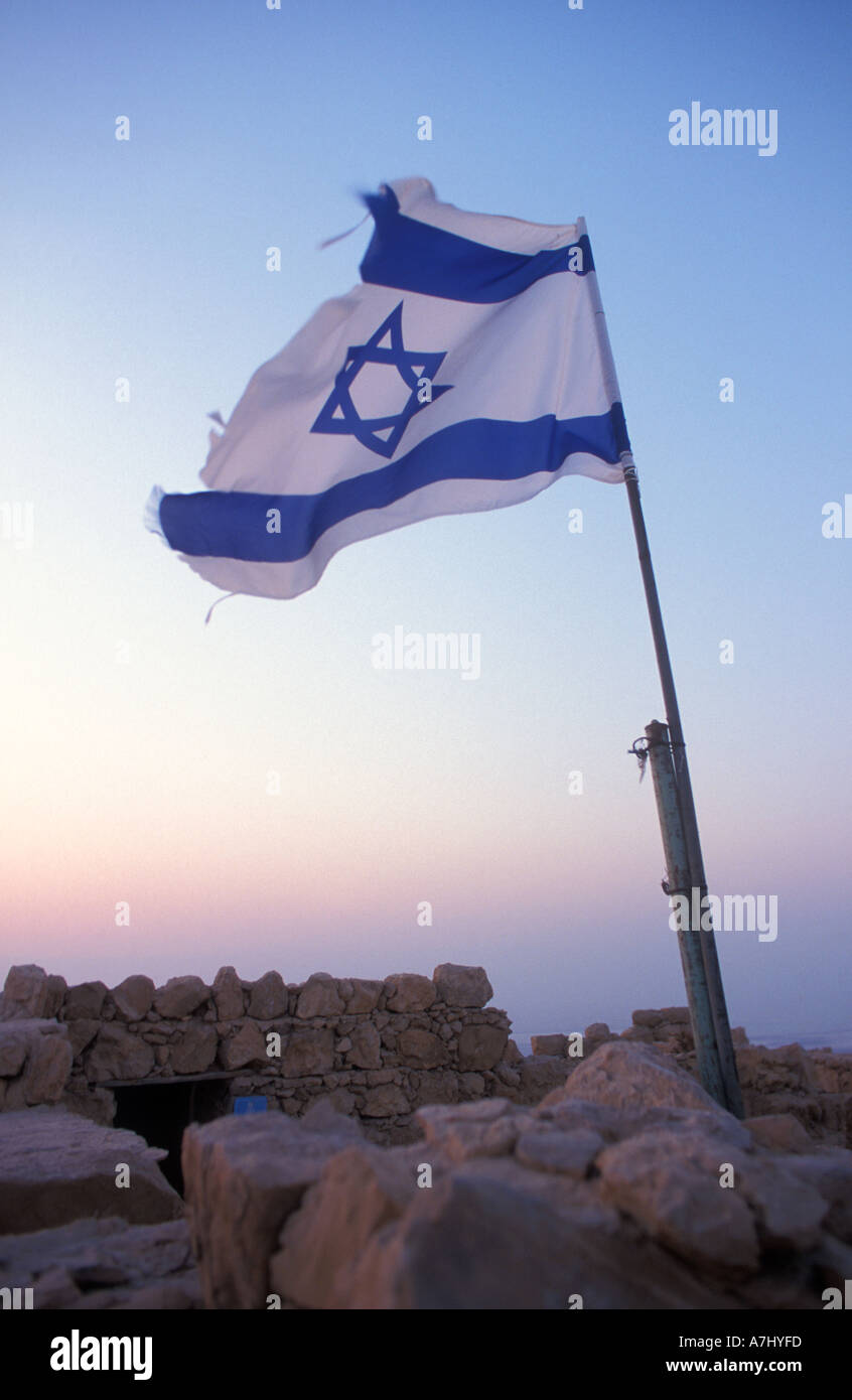 ISRAEL flag at dawn in the legendary Masda Fortress of Herod in the desert near the Dead Sea Stock Photo