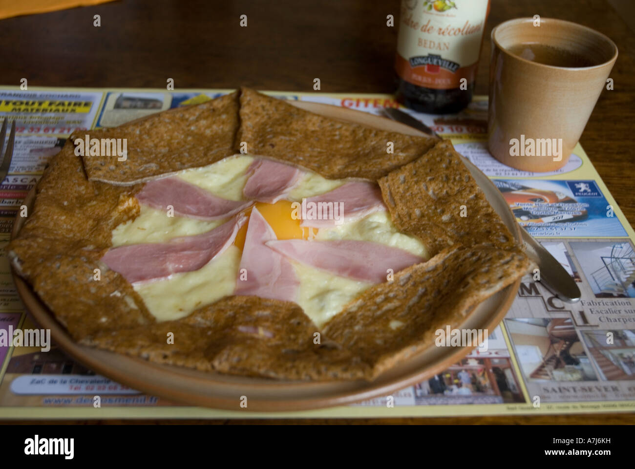 A 'gallette', a French savoury pancake, with a cup of cider. This is a 'complet' with ham egg and cheese Stock Photo