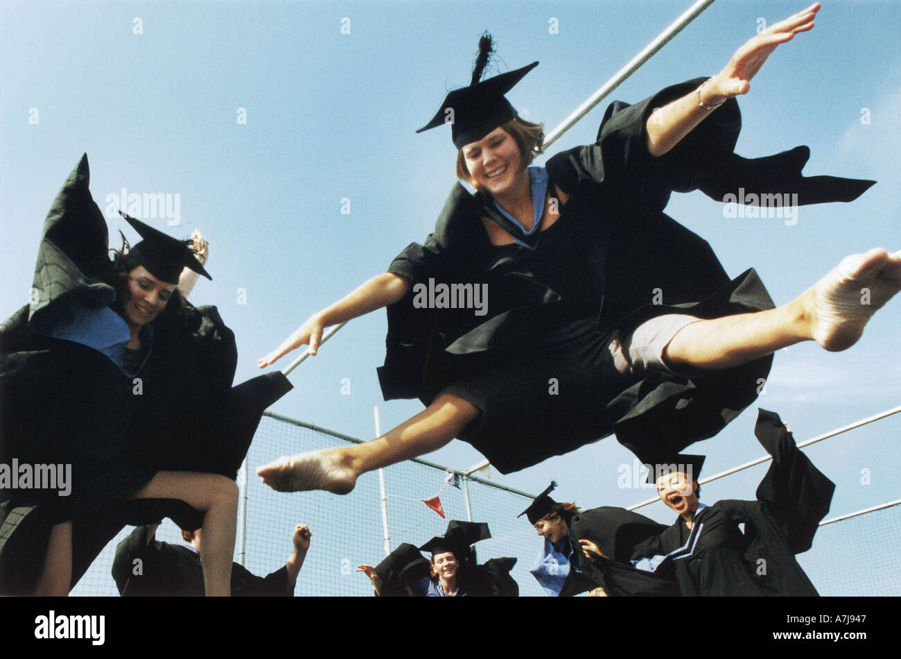 University of Brighton Performing arts students celebrate  their graduation on a trampoline on Brighton seafront Stock Photo