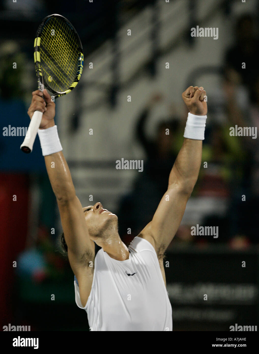 Tennis pro Rafael Nadal throws arms up in the air after winning the final  of the Dubai Duty Free Men's Open Stock Photo - Alamy
