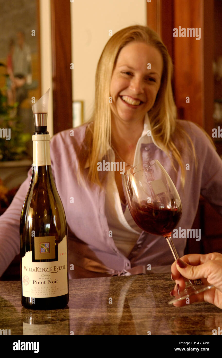 Cellar club manager Angelina Huxen pours wine at Willakenzie Estate Willamette Valley Oregon Stock Photo