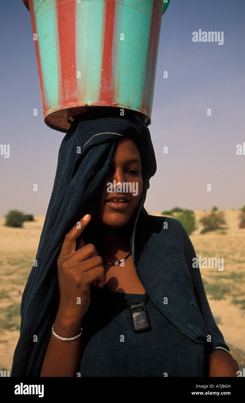 Tuareg woman collecting water from a well in the Sahara desert , Timbuktu, Mali Stock Photo