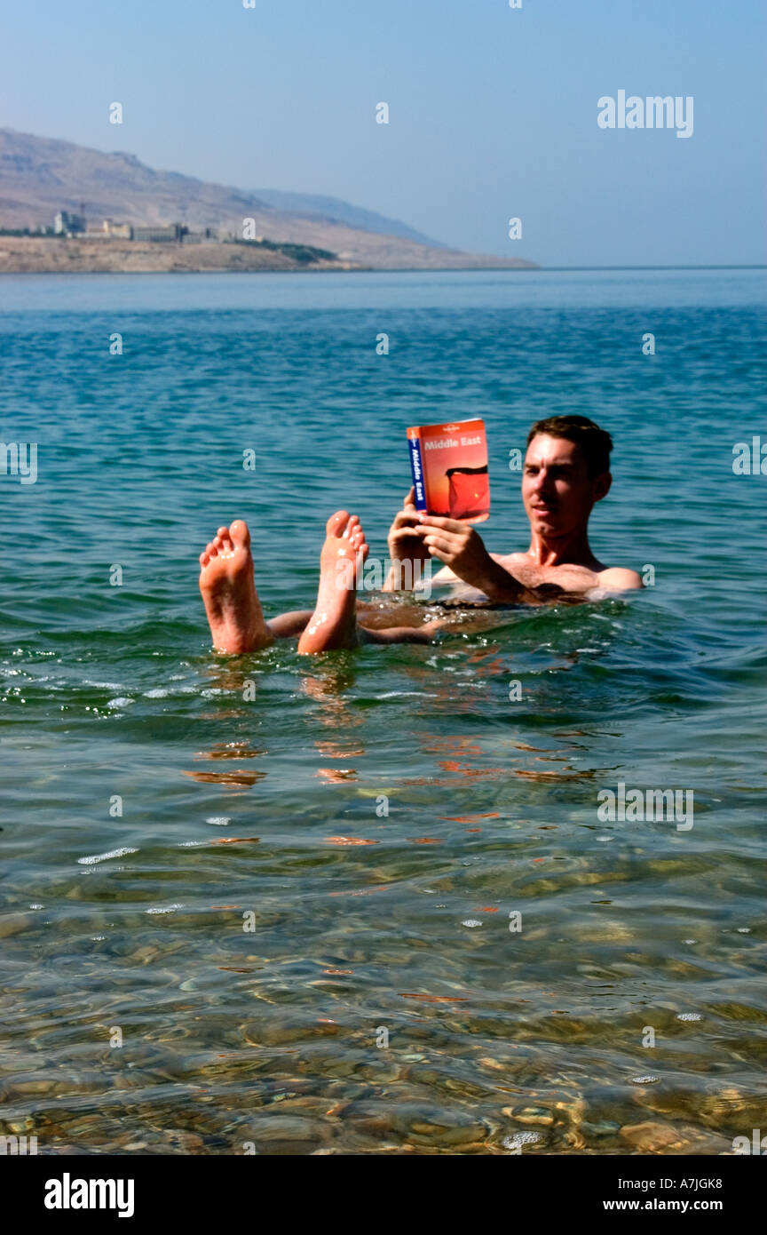 tourist floating in sea reading Jordan guide book Dead Sea Jordan Middle East Model Release Stock Photo -
