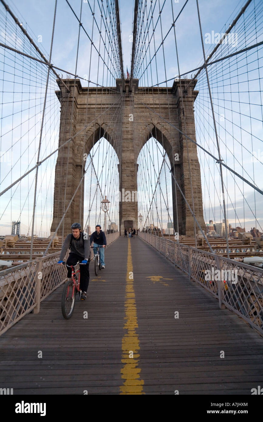 Bicyclists cross Brooklyn Bridge in the early evening Stock Photo Alamy