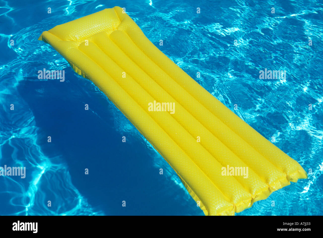 Yellow floating device in pool Stock Photo Alamy