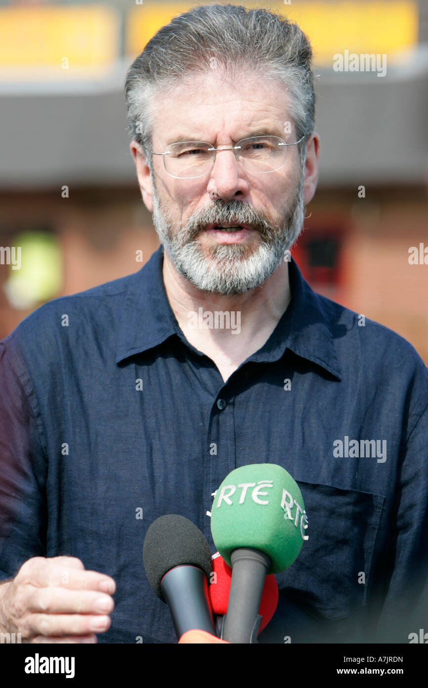 Gerry Adams speaking into microphones and gesticulating at a street press conference in West Belfast Stock Photo