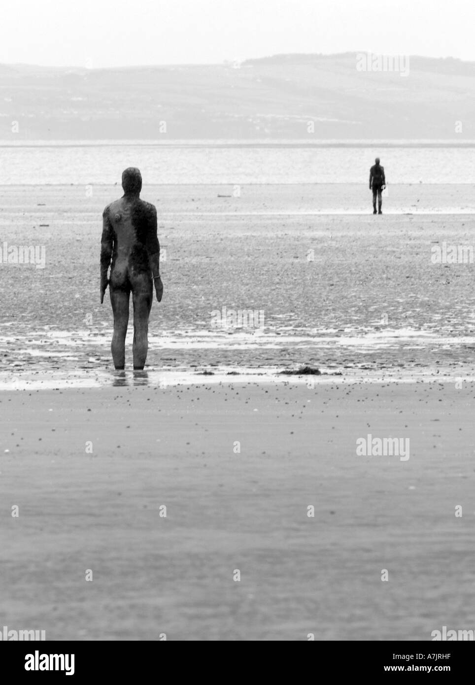 ANTONY GORMLEY SCULPTURED FIGURES ON BEACH AT CROSBY, LIVERPOOL