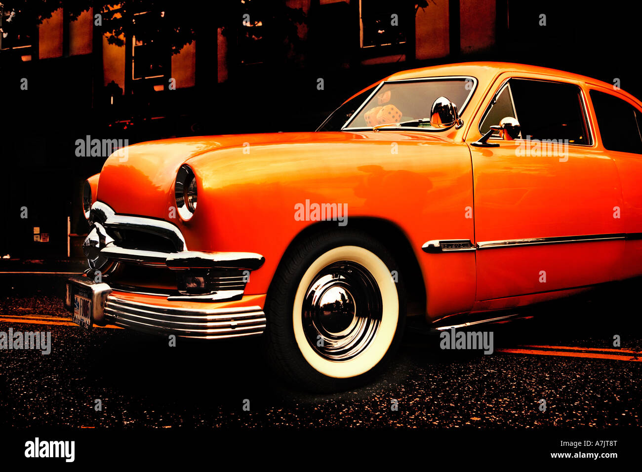 classic 1950 Ford orange parked on the road on double yellow line Stock Photo