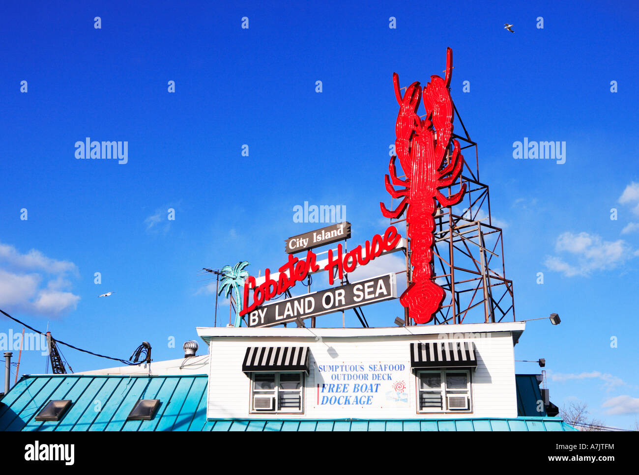 City Island Lobster House restaurant in Bronx NYC with giant red lobster on sign atop the roof of the building Stock Photo
