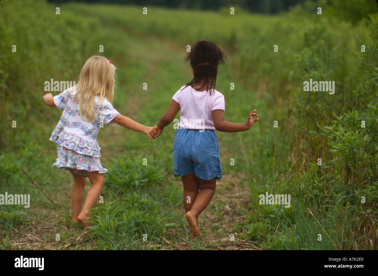 Little girls walking outdoors horizontal Stock Photo - Alamy