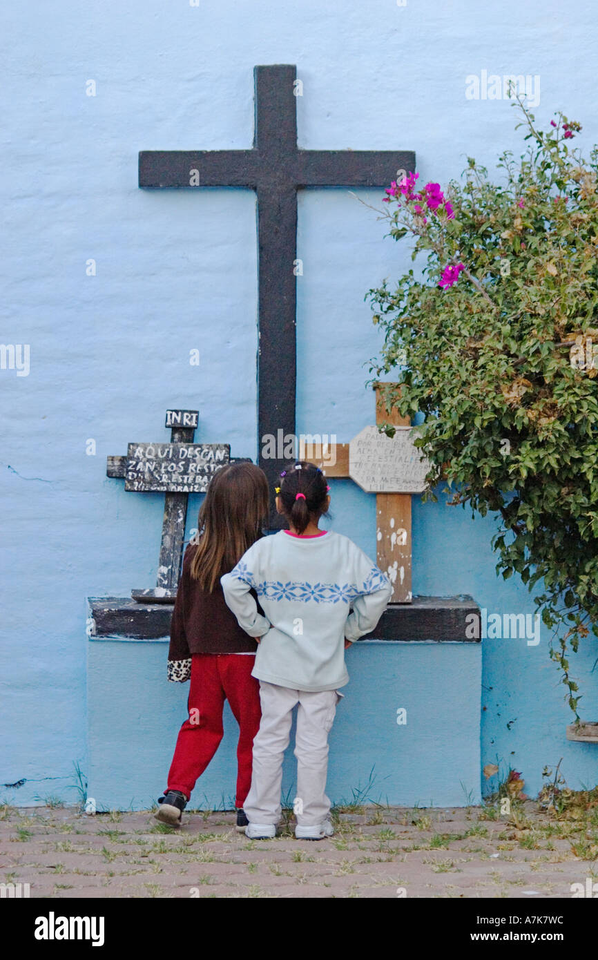 Mexican girls examine crosses at the local cemetery during the DEAD OF THE DEAD SAN MIGUEL DE ALLENDE MEXICO Stock Photo