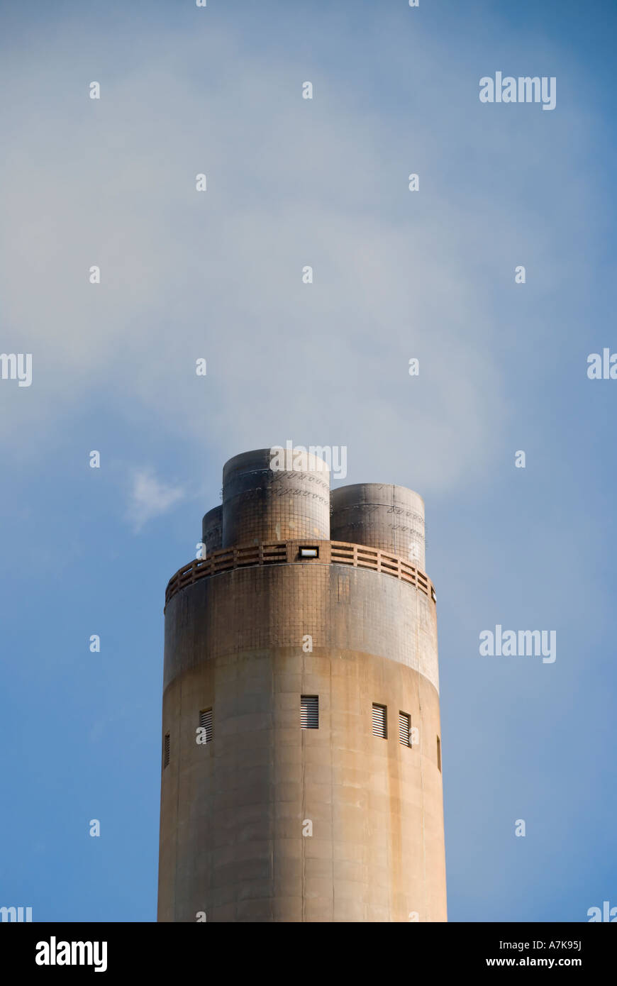A smoking power  station chimney  stack on a plain blue sky - Aberthaw Power Station, South Wales. UK. Stock Photo