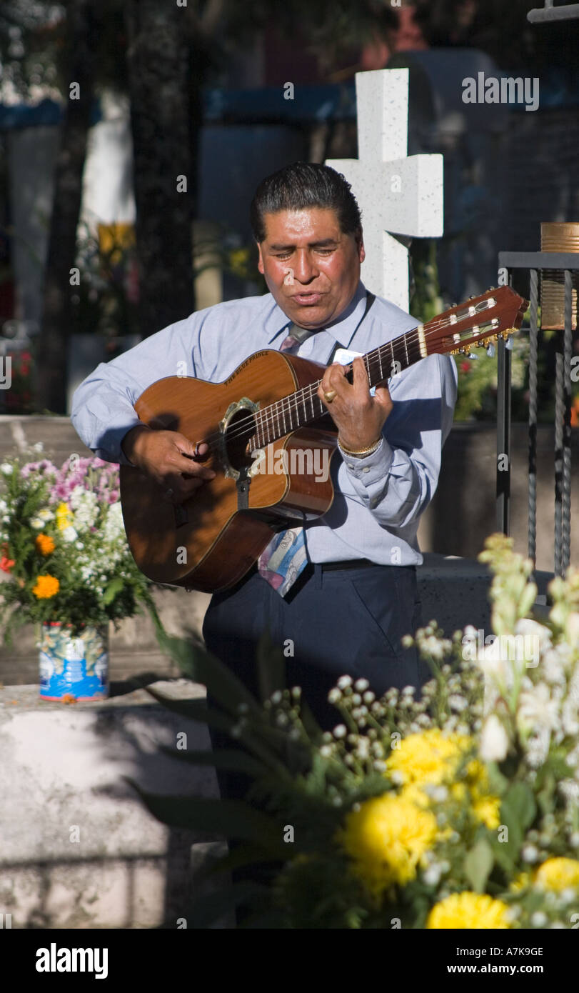 A GUITARIST plays for the dead at the local cemetery during the DEAD OF THE DEAD SAN MIGUEL DE ALLENDE MEXICO Stock Photo