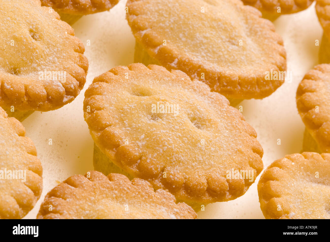Mince pies dusted with icing sugar on a white background. Stock Photo