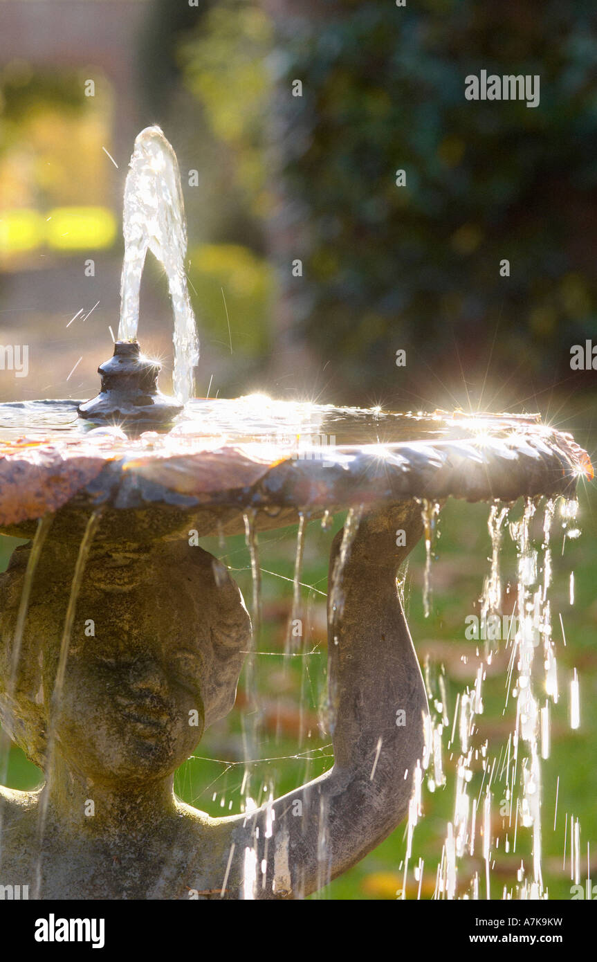 Sparkling water on a backlit garden fountain. UK Stock Photo Alamy