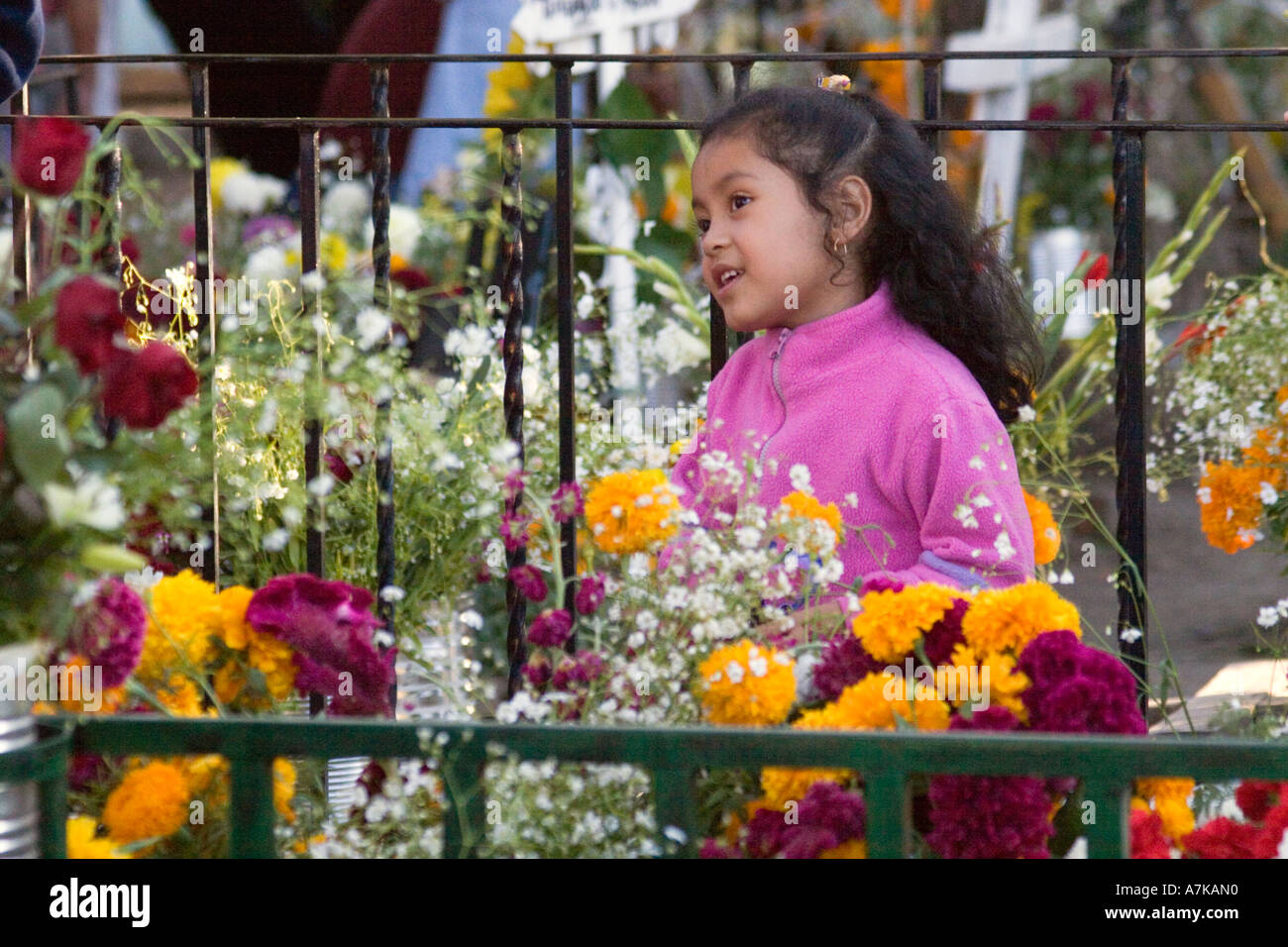 A young MEXICAN girl visits a grave during the DEAD OF THE DEAD SAN MIGUEL DE ALLENDE MEXICO Stock Photo