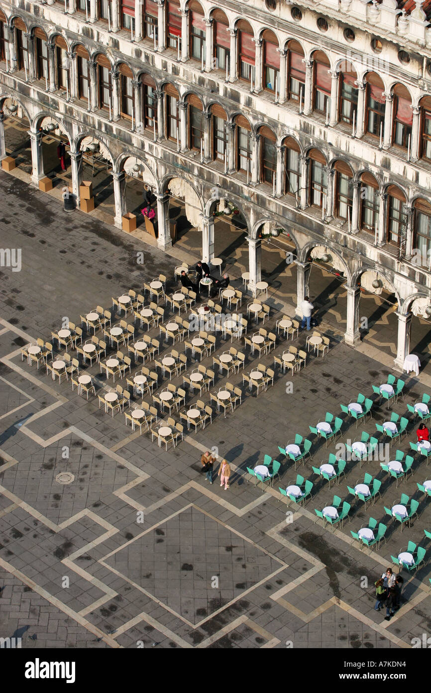 Aerial view of expensive restaurant and cafe chairs and tables in St Marks Square Venice from top of the Bell tower Italy EU Stock Photo