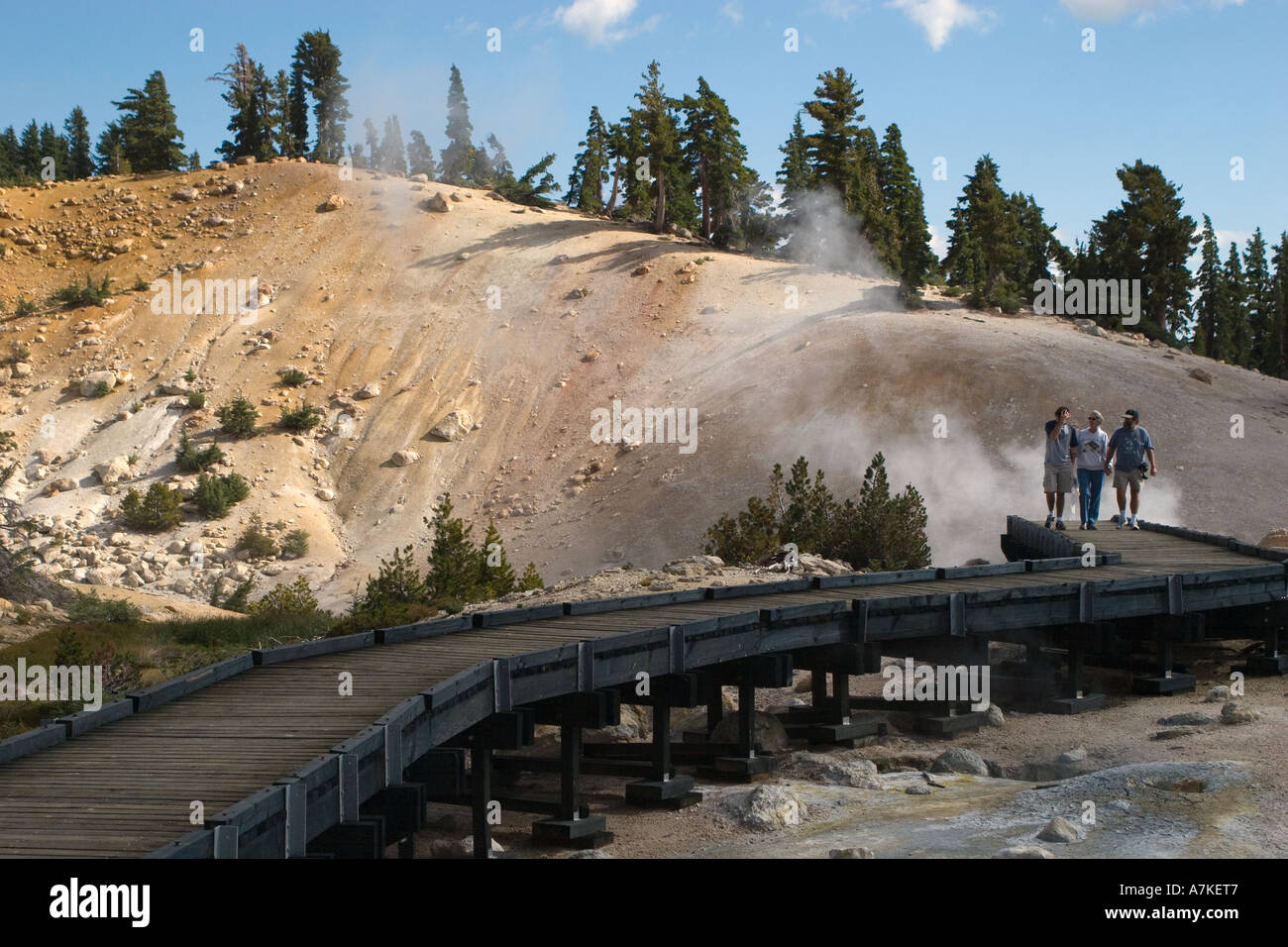 Steam engulfs visitors on a wooden pathway at the hot sulphur springs of BUMPASS HELL LASSEN NATIONAL PARK CALIFORNIA Stock Photo