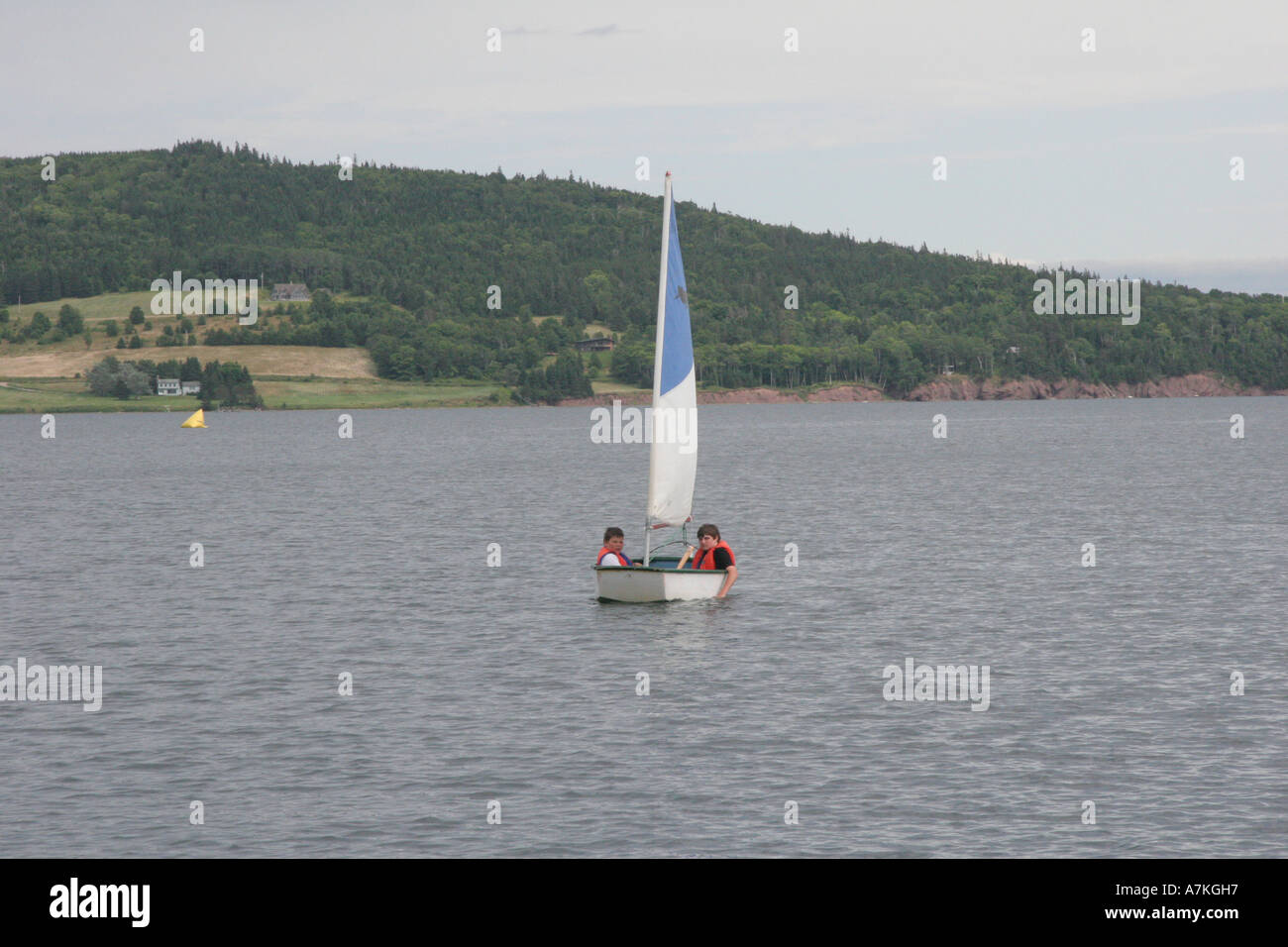 Youngsters in a sailing dinghy at Baddeck Nova Scotia Stock Photo Alamy