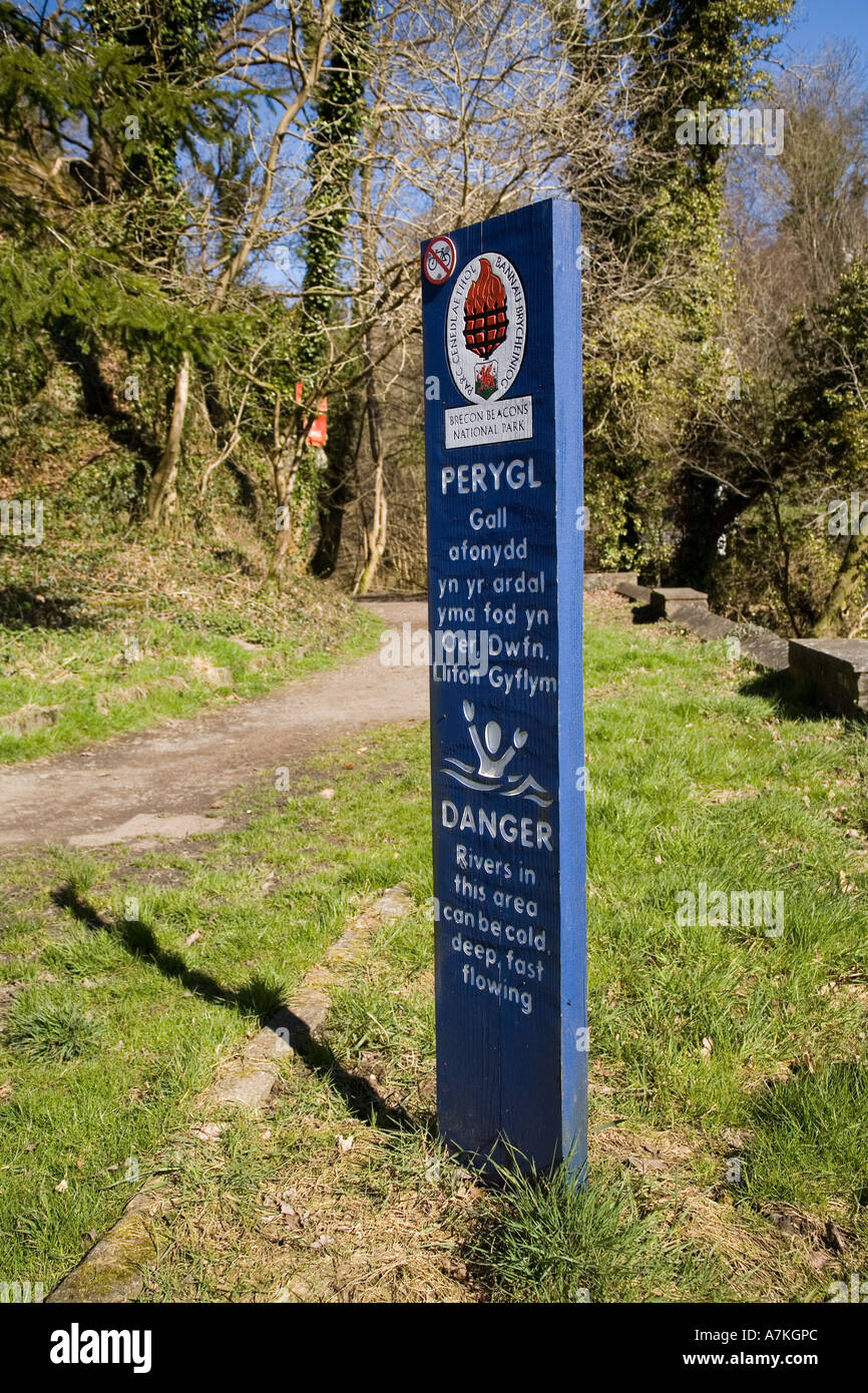 Bilingual warning sign for dangerous rivers no swimming Brecon Beacons National Park Glyn Neath Wales UK Stock Photo