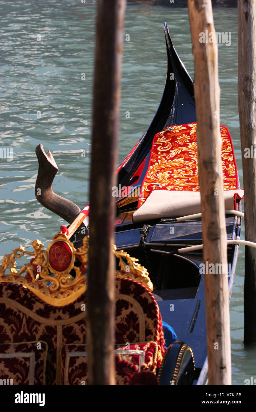 Close up details of a typical Venetain gondola moored on the Grand Canal near the Ponte di Rialto Bridge landmark Venice Italy Stock Photo